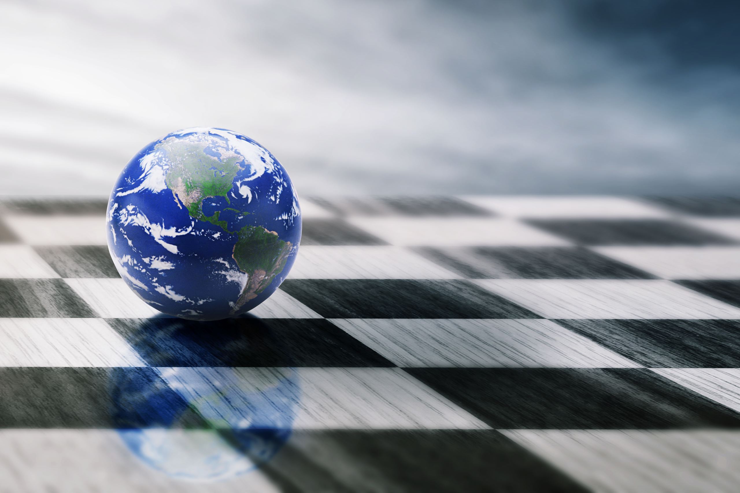 A marble that looks like the world on a black and white chess board.